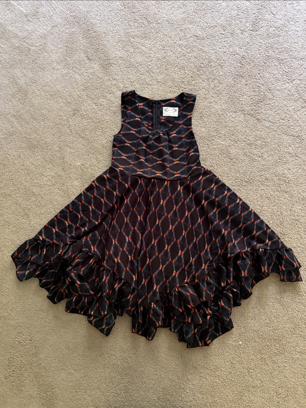 Girls Black Dress with Red Geometric Print and Ruffle Hem